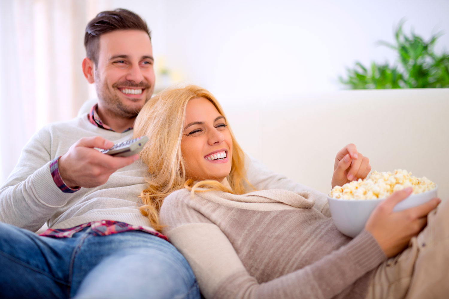 Couple watching movie in home theatre room
