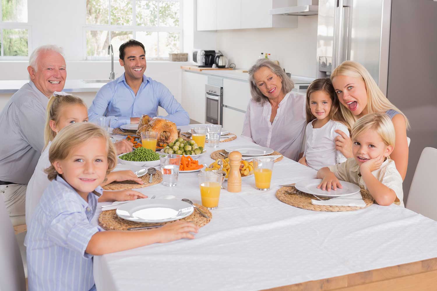 Family enjoying dinner at their wooden extendable dining table